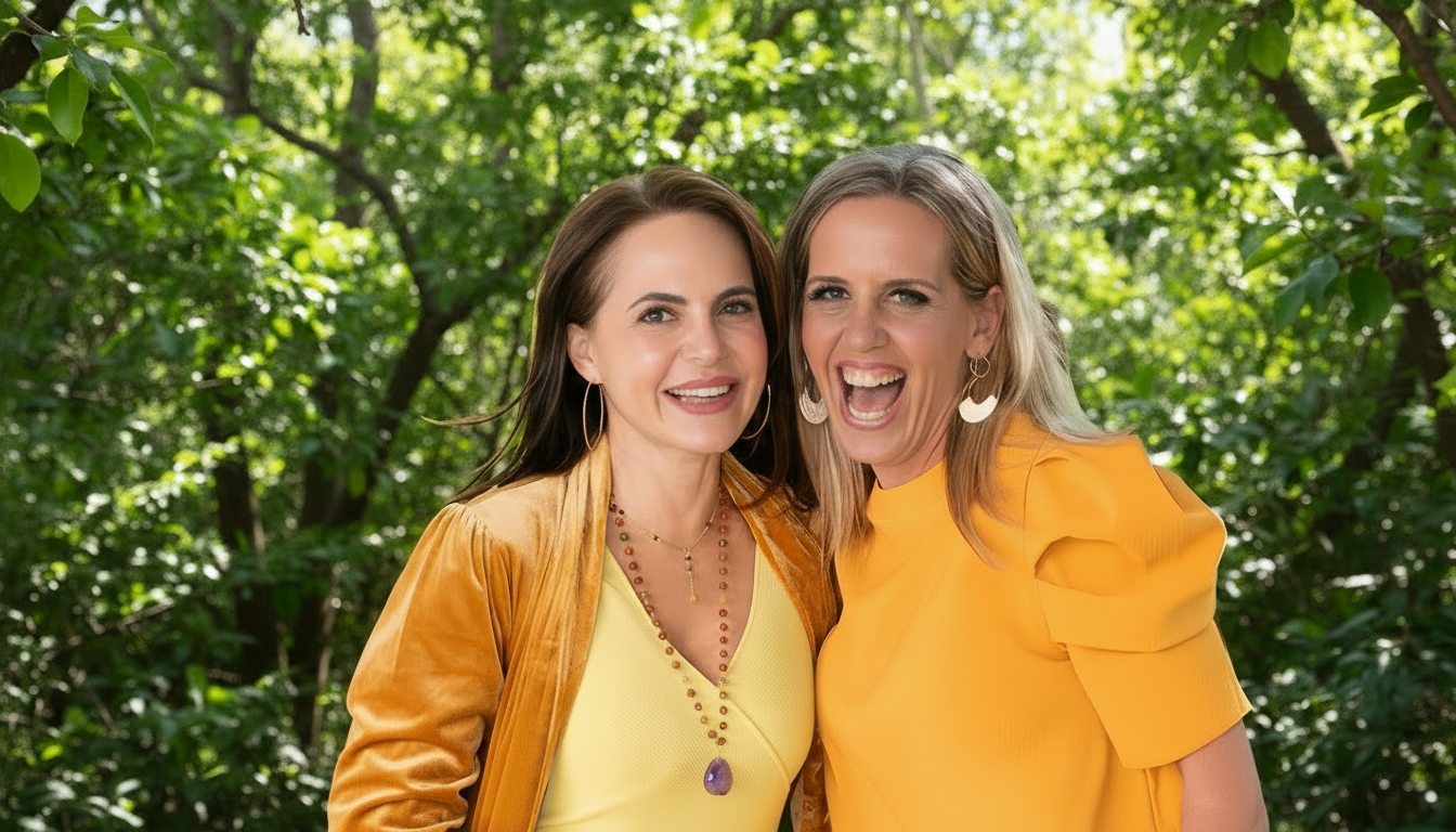 Two holistic women psychologists  in yellow outfits smiling outdoors with a blurred background